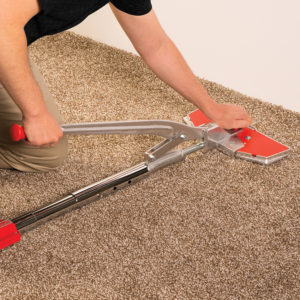 Big Red's carpet stretching experts use the power stretcher for carpet stretching and carpet re-stretching in Omaha, NE.